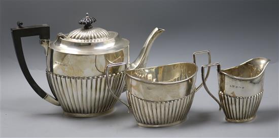 A George V demi fluted silver three piece tea set, Birmingham, 1919/1921, gross 27 oz.